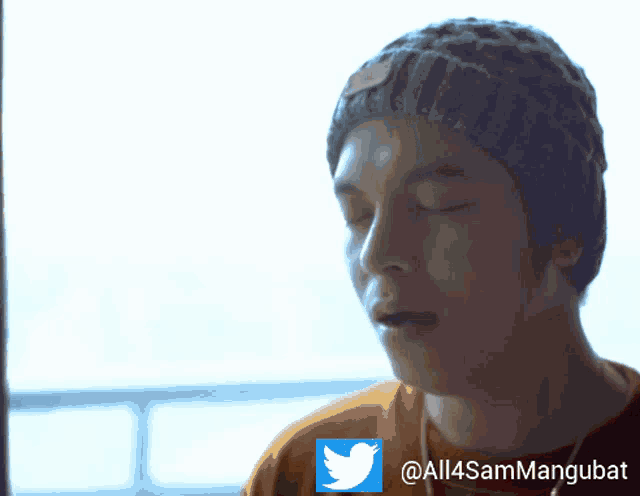 a man wearing a beanie and a red shirt has a twitter icon next to him