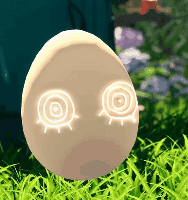 a white egg with glowing eyes and circles on it sits in the grass