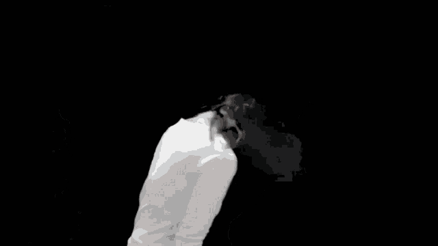 a black and white photo of a woman wearing a cowboy hat and a white shirt .