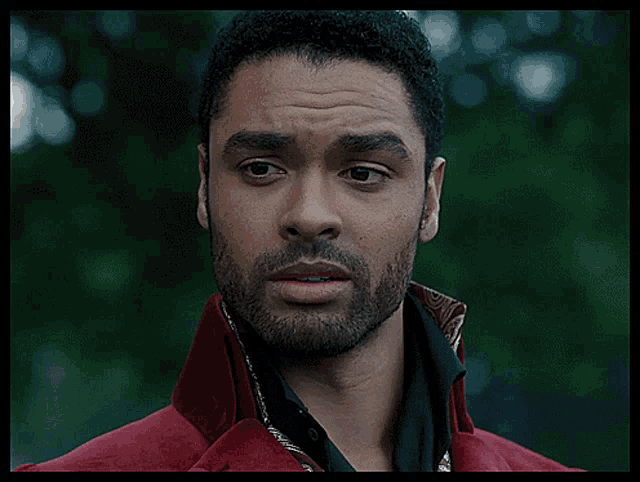 a man with a beard wearing a red jacket