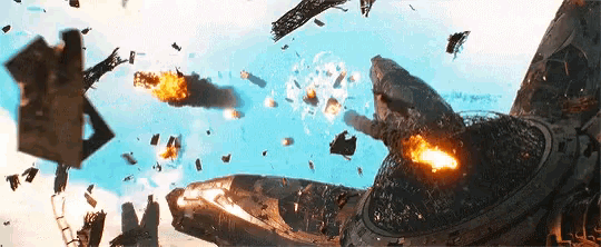 a fighter jet is flying through the air with a lot of explosions