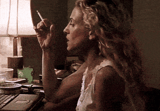a woman is smoking a cigarette in front of a lamp