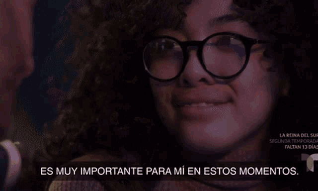 a man in a suit and tie is smiling and talking to a woman in spanish