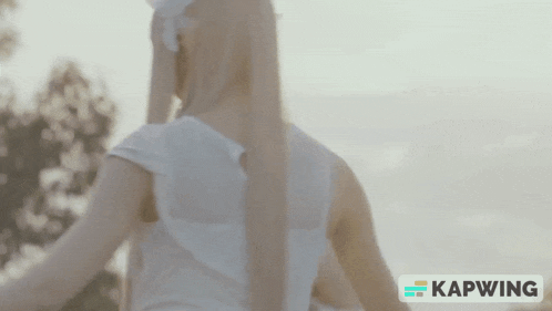 a woman 's back is shown in a kapwing video