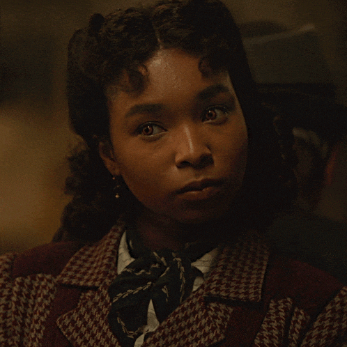 a close up of a woman 's face with a bow tie