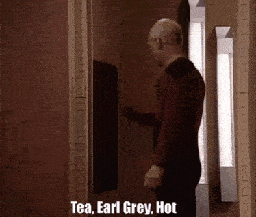 a man standing in a doorway with the words tea earl grey hot written on it