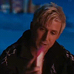 a close up of a man 's face with a red light coming out of his mouth