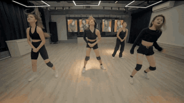 a group of young women are dancing in a studio