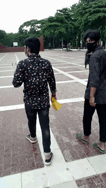 a man wearing a mask is walking with another man