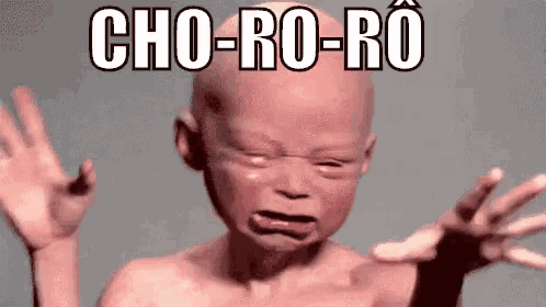 a baby with a bald head is crying with the words cho-ro-ro written above him .