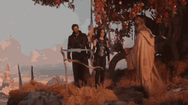 a man and a woman are standing next to each other under a tree