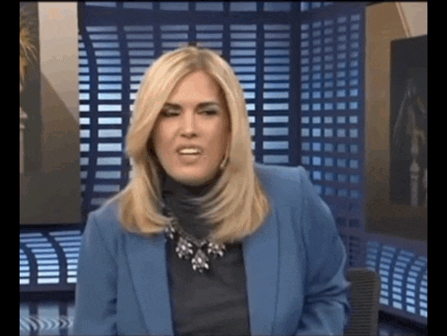 a blonde woman wearing a blue jacket and a black turtleneck