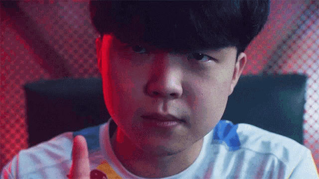 a close up of a young man 's face with a cherry in his hand .