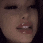 a close up of a woman 's face with a lot of lipstick on it .