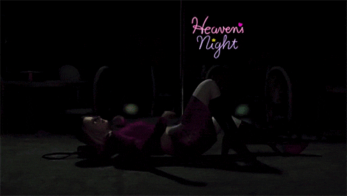 a woman is laying on the ground under a sign that says heavenly night