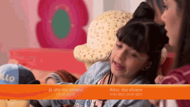 a little girl is crying in front of a sign that says " hello "