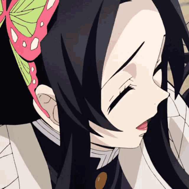 a close up of a girl 's face with her eyes closed and a flower in her hair