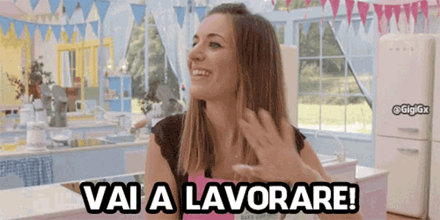 a woman in a kitchen with the words vai a lavorare above her