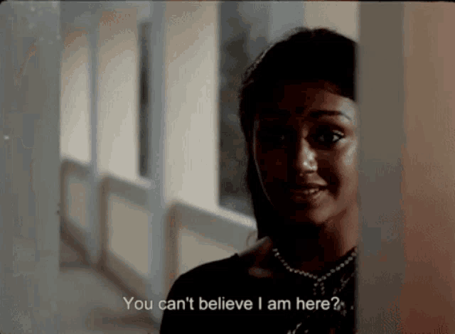 a woman in a hallway with the words " you can 't believe i am here "