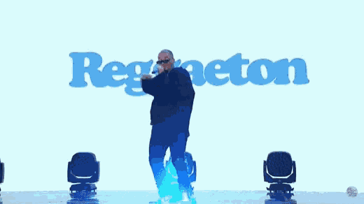 a man stands on a stage in front of a screen that says regston