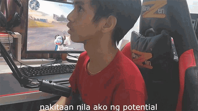 a man in a red shirt sits in front of a computer with the words " nakitaan nila ako ng potential " on the bottom