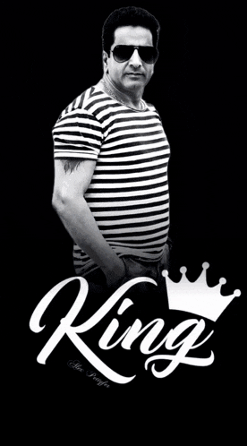 a man wearing sunglasses and a striped shirt with the word king written on it