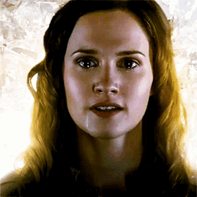 a woman with a tear running down her face