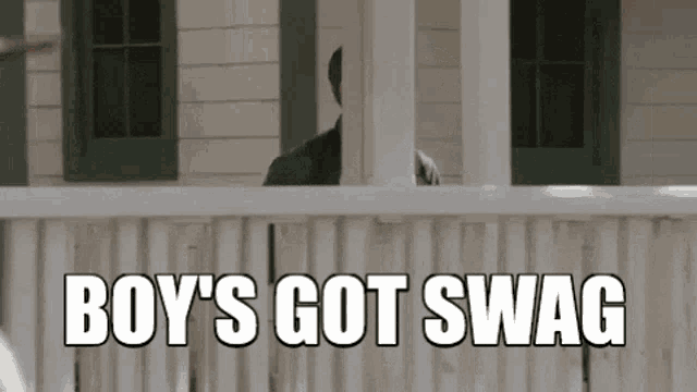 a man standing on a porch with the words boy 's got swag written on it
