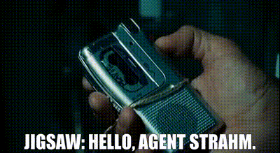 a person is holding a flip phone with the words jigsaw hello agent strahm written below it