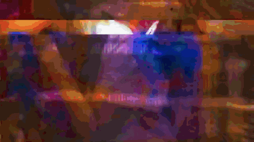 a close up of a film reel with a rainbow of colors on it
