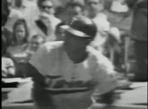 a black and white photo of a man in a dodgers uniform
