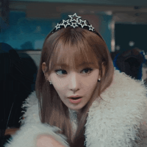 a woman wearing a fur coat and a tiara has a surprised look on her face
