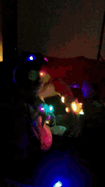 a person laying on a bed with a blue light on the floor