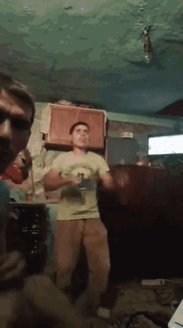 a man in a t-shirt that says ' i love you ' on it is dancing in a living room