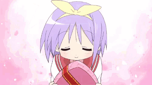 a little girl with purple hair is holding a pink box