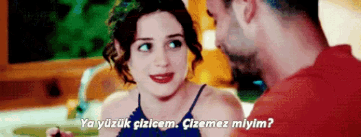 a man and a woman are looking at each other and the woman says ya yüzük cizcem cizemez miyim