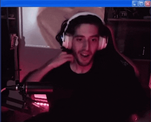 a man wearing headphones is playing a game on a computer