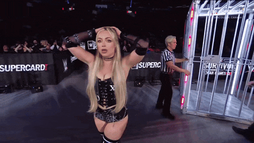 a woman stands in front of a supercard banner