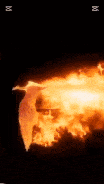 a person is standing in front of a fire with abc written on the bottom right