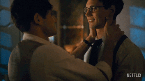 two men kissing in front of a netflix ad