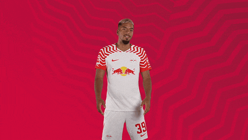 a soccer player wearing a red and white jersey with the number 39