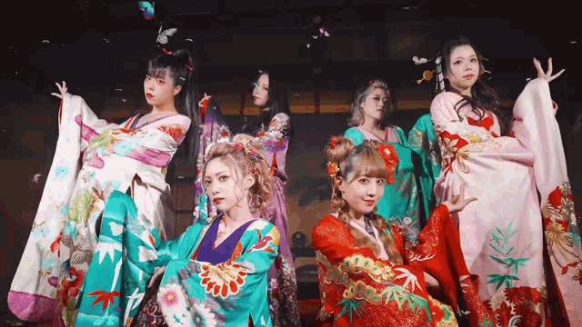 a group of women in kimonos are posing for a photo
