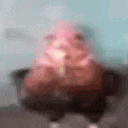a blurry picture of a person sitting on a couch with a pink shirt on .