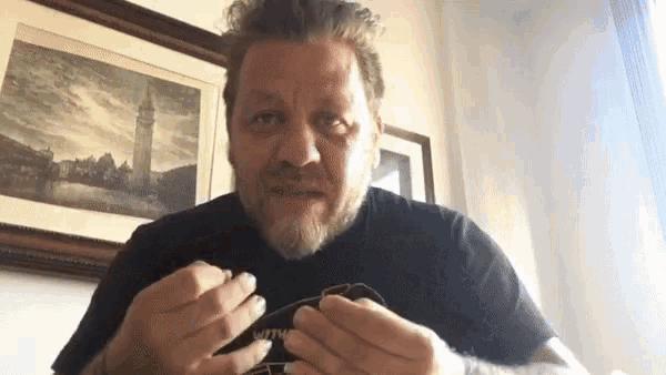 a man with a beard wearing a black shirt with the word metallica on it