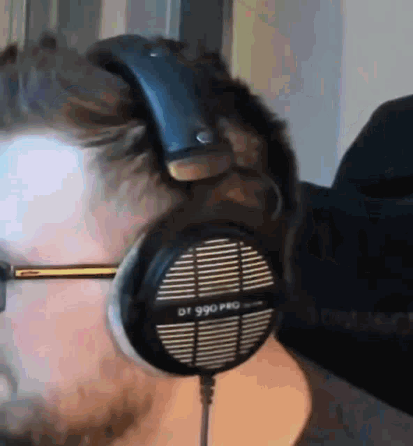 a man is wearing a pair of headphones that say dt 990 pro