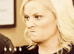 a woman is making a funny face and making a funny face .