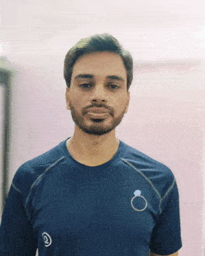 a man with a beard is wearing a blue shirt with a ring on the back