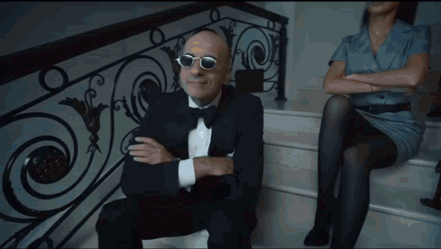 a bald man wearing a robe is dancing in a living room