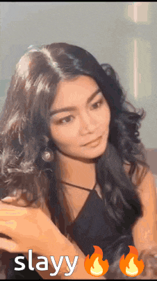 a woman in a black dress with the word slayy on the bottom right