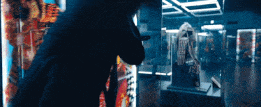 a person in a dark room looking at a display
